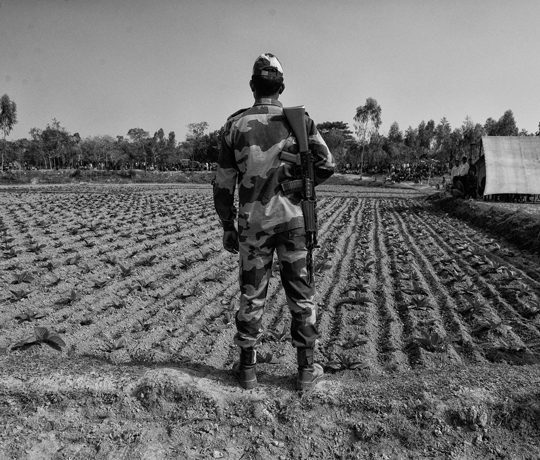 A soldier belonging to the BSF stands guard on the No Man’s Land between Bangladesh and India’s border at Lalmonirhat while a flag meeting between BGB and BSF is going on.